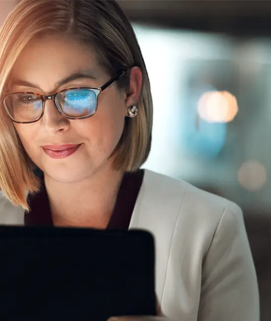 Executive assistant using a tablet, representing high-trust administrative support for family offices.