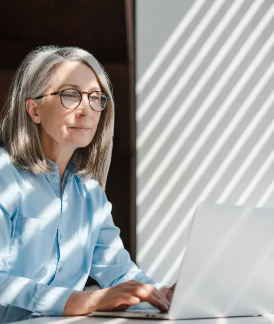Experienced professional working on a laptop, representing private family office operations management and governance.
