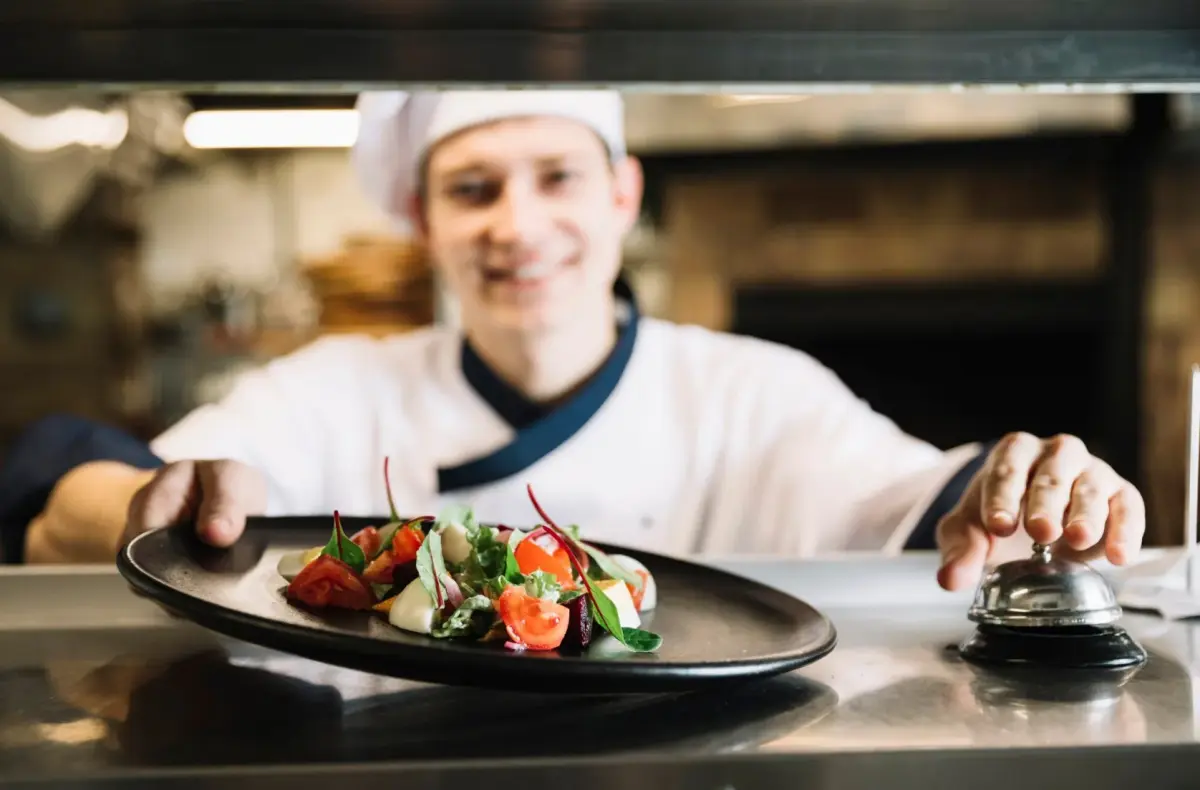 A chef meticulously plating a dish in a professional kitchen setting