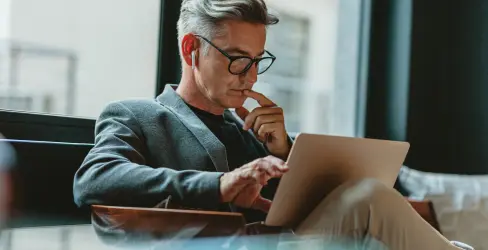 Private office founder reviewing plans on a tablet while preparing to make the first strategic hire for a new family office.