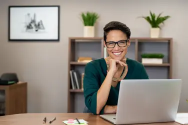 Family office Chief of Staff working at a laptop in a private office