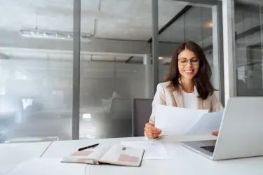 Recruitment professional reviewing candidate documents, representing trust-led hiring for UHNW private staff and family office roles.