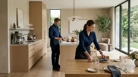 Household staff setting a dining table and reviewing tasks in a luxury private residence, representing a practical guide to hiring staff for UHNW households.